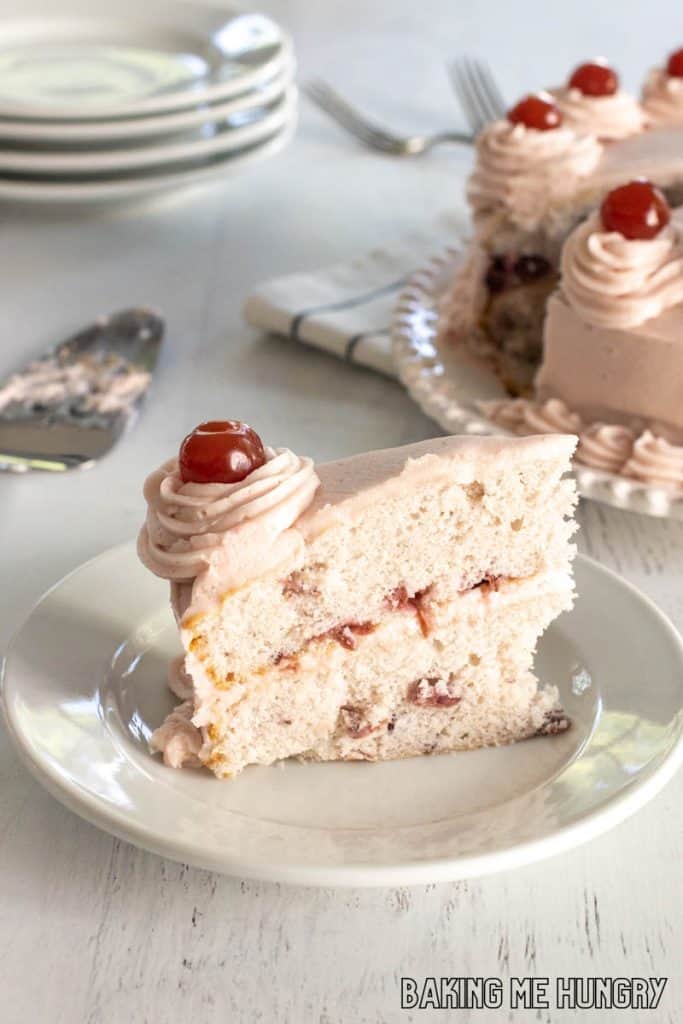 cherry chip cake slice on a plate with remaining cake behind