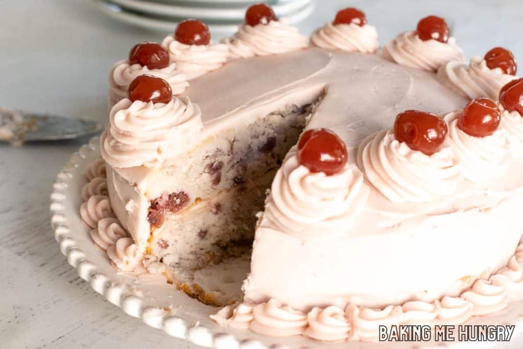 cherry chip cake recipe on serving plate with piece missing
