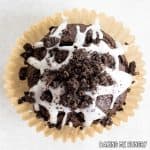 one of the chocolate oreo muffins sitting on its paper wrapper from overhead