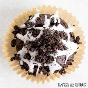 one of the chocolate oreo muffins sitting on its paper wrapper from overhead
