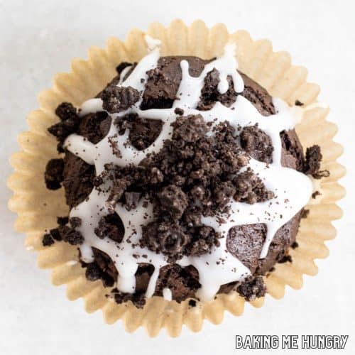 one of the chocolate oreo muffins sitting on its paper wrapper from overhead