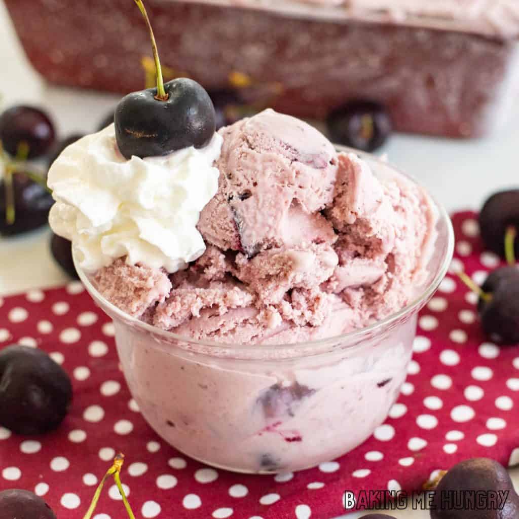 amaretto cherry ice cream served in dish from side with whipped cream and a sweet cherry