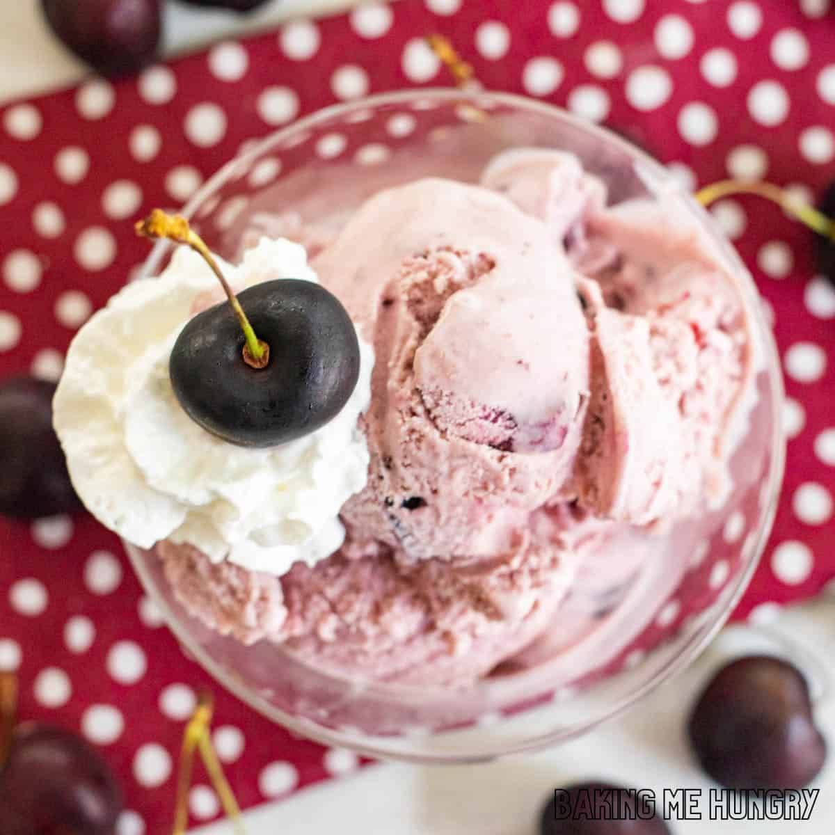 amaretto cherry ice cream recipe in a small glass dish from overhead with whipped cream and a black cherry