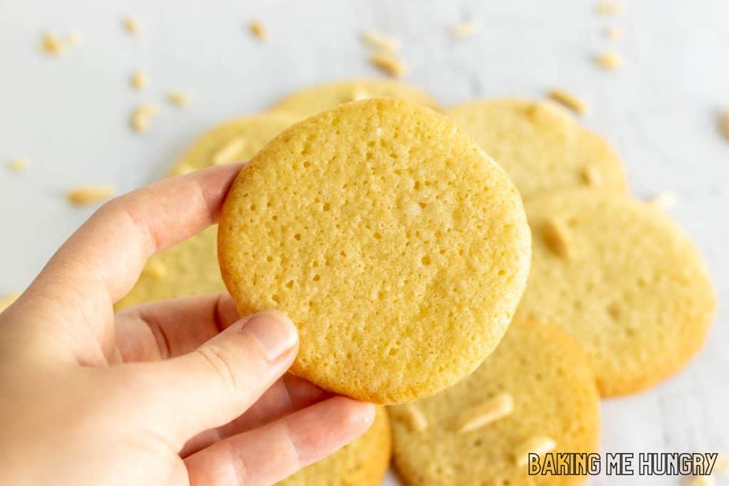 hand holding up an almond cookie