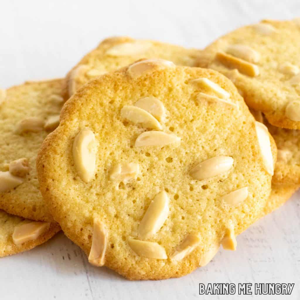 crisp almonds cookies in a pile with one close up