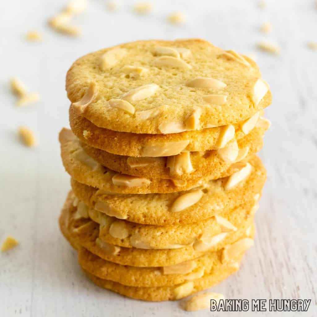 crisp almond cookies with slivered almonds in a tall stack