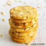 crisp almond cookies with slivered almonds in a tall stack