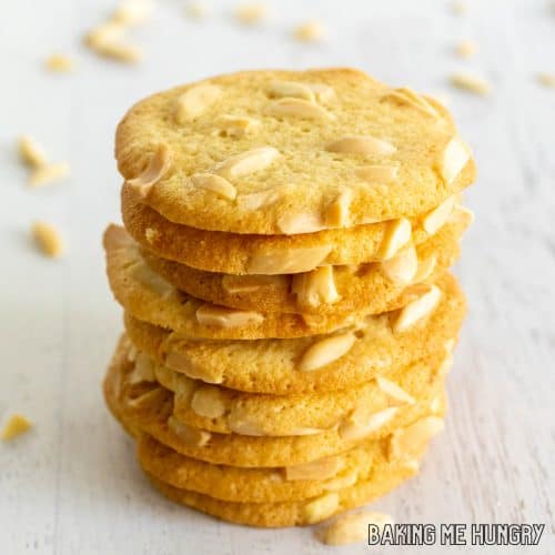 crisp almond cookies with slivered almonds in a tall stack