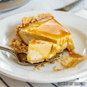 no bake caramel cheesecake slice on plate with a bite on a fork resting on the plate