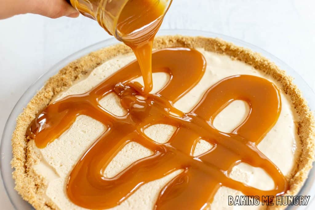 caramel being poured on cheesecake