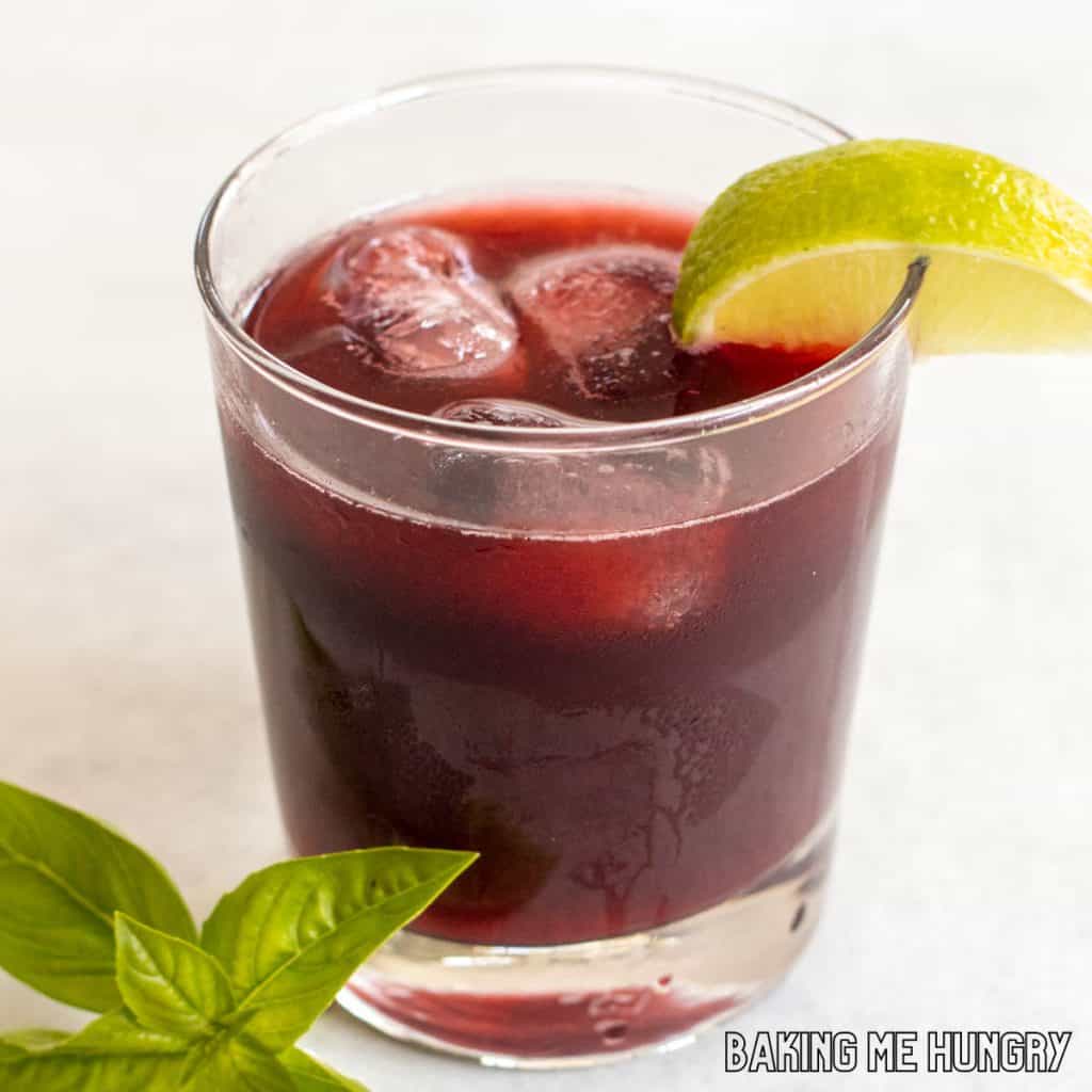 blackberry mocktail in glass with lime wedge