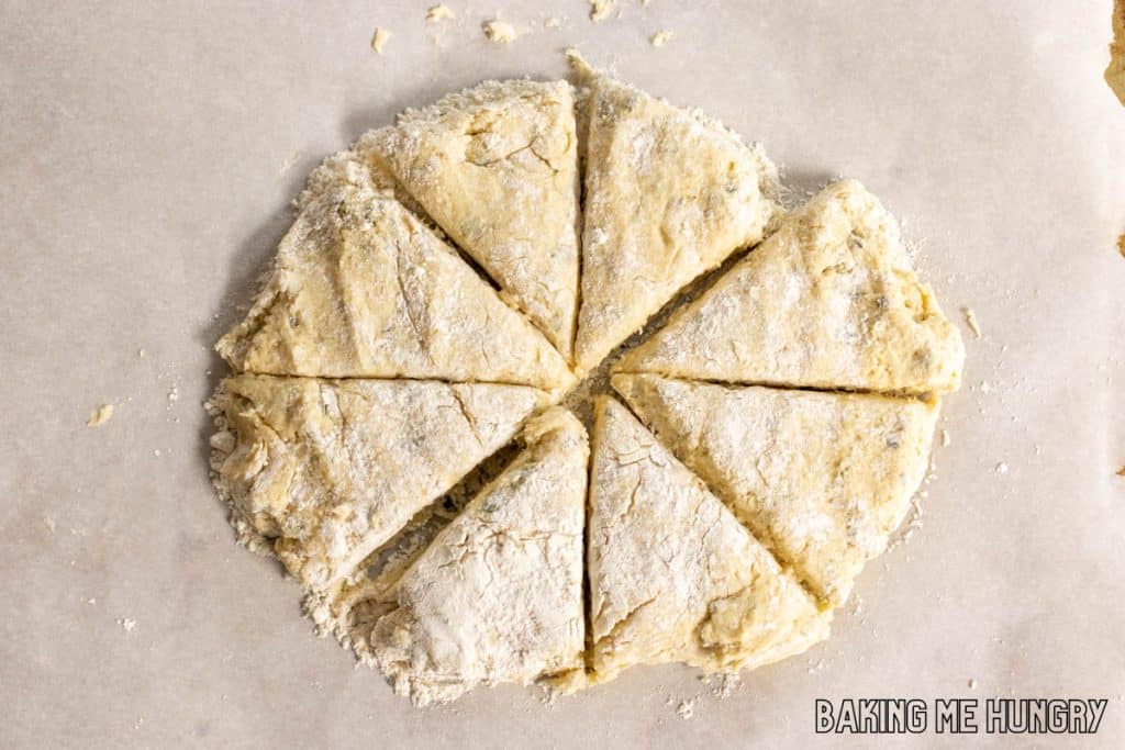 circle of dough cut into wedges on parchment