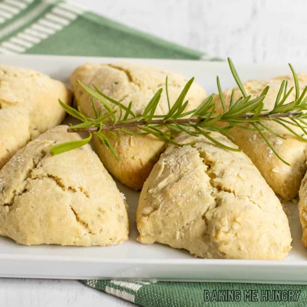 herb scones recipe on serving platter close up with fresh rosemary garnish