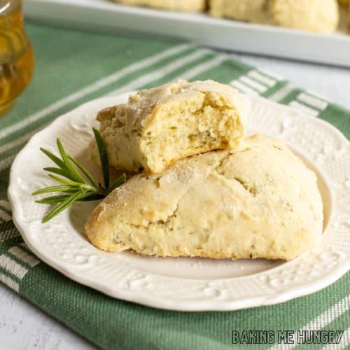 herb scones on a small plate close up with top scone missing a bite