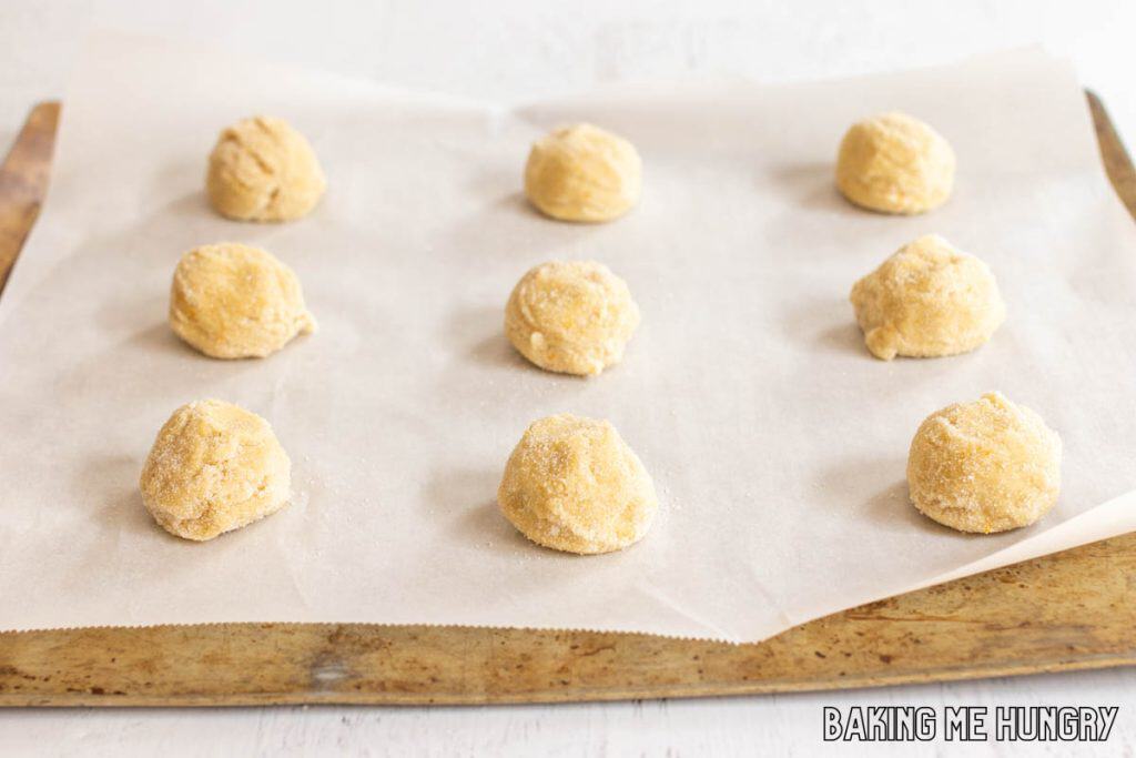 balls of dough on parchment lined baking sheet