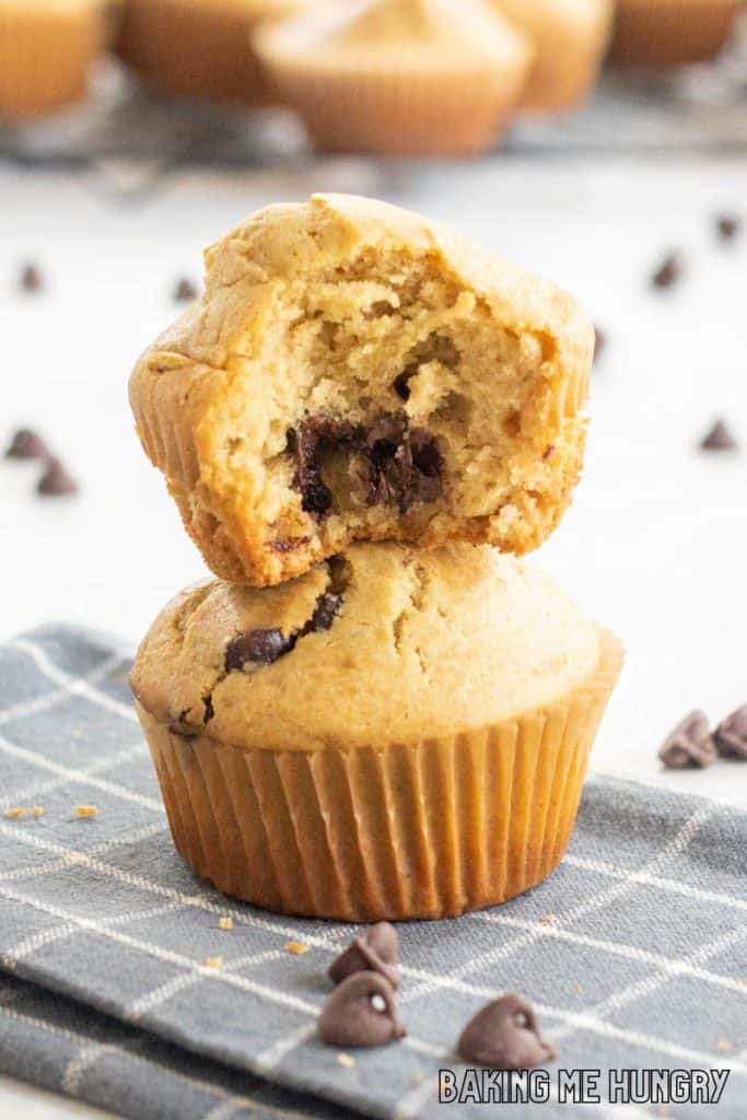 peanut butter chocolate chip muffins stacked with bite missing from top muffin