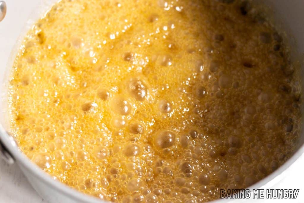 bubbly light brown liquid in small pot