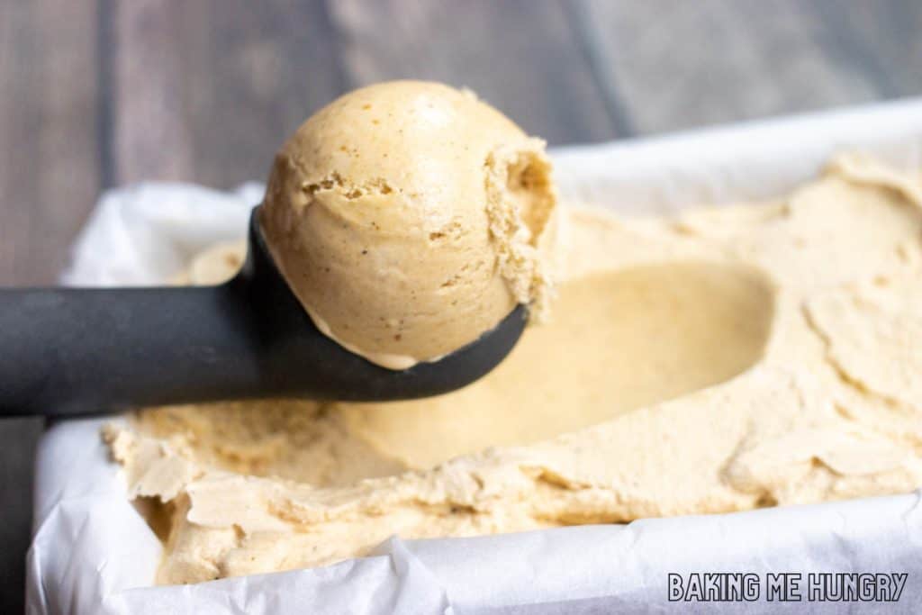 scoop of pumpkin spice ice cream held up on ice cream scoop