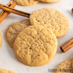 pumpkin spice sugar cookies in a small pile with cinnamon sticks around
