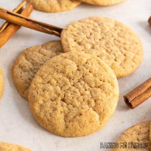 pumpkin spice sugar cookies in a small pile with cinnamon sticks around
